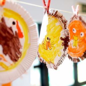 Cocoon Childcare - Children's paintings hanging to dry