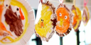 Cocoon Childcare - Children's paintings hanging to dry