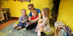 Cocoon Childcare staff reading to children