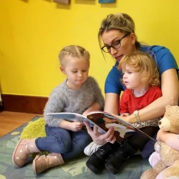 Cocoon Childcare staff reading to children