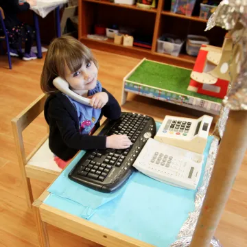 Cocoon Childcare Child playing with a telephone